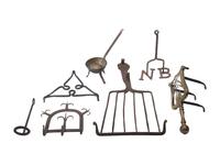 [CAMP LIFE]. A group of branding irons, utensils, and other camp tools.