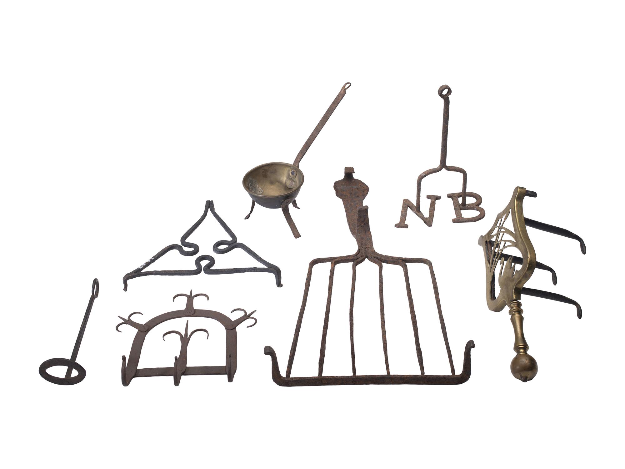 [CAMP LIFE]. A group of branding irons, utensils, and other camp tools.