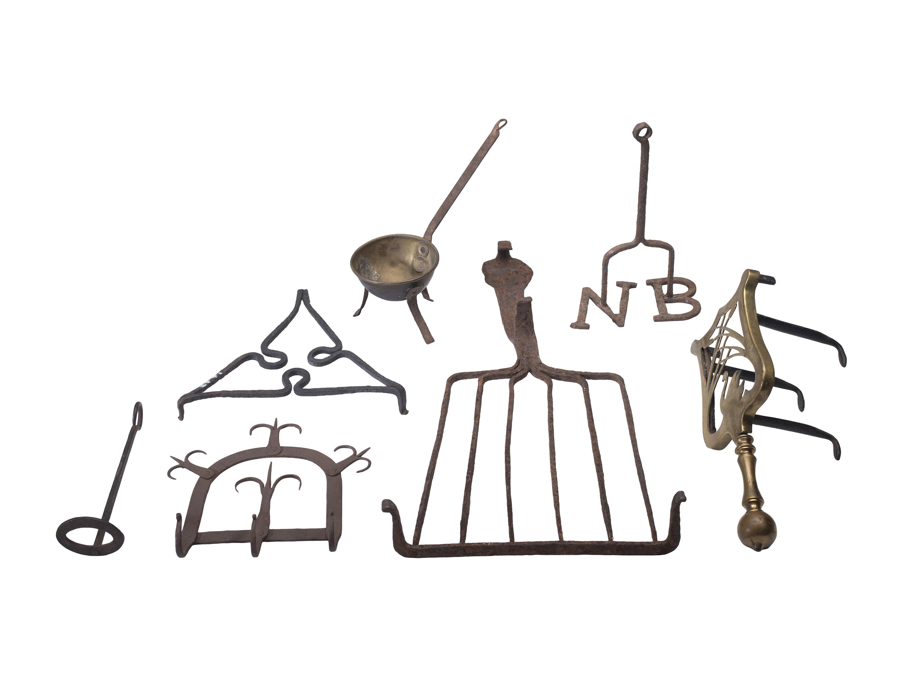 [CAMP LIFE]. A group of branding irons, utensils, and other camp tools.