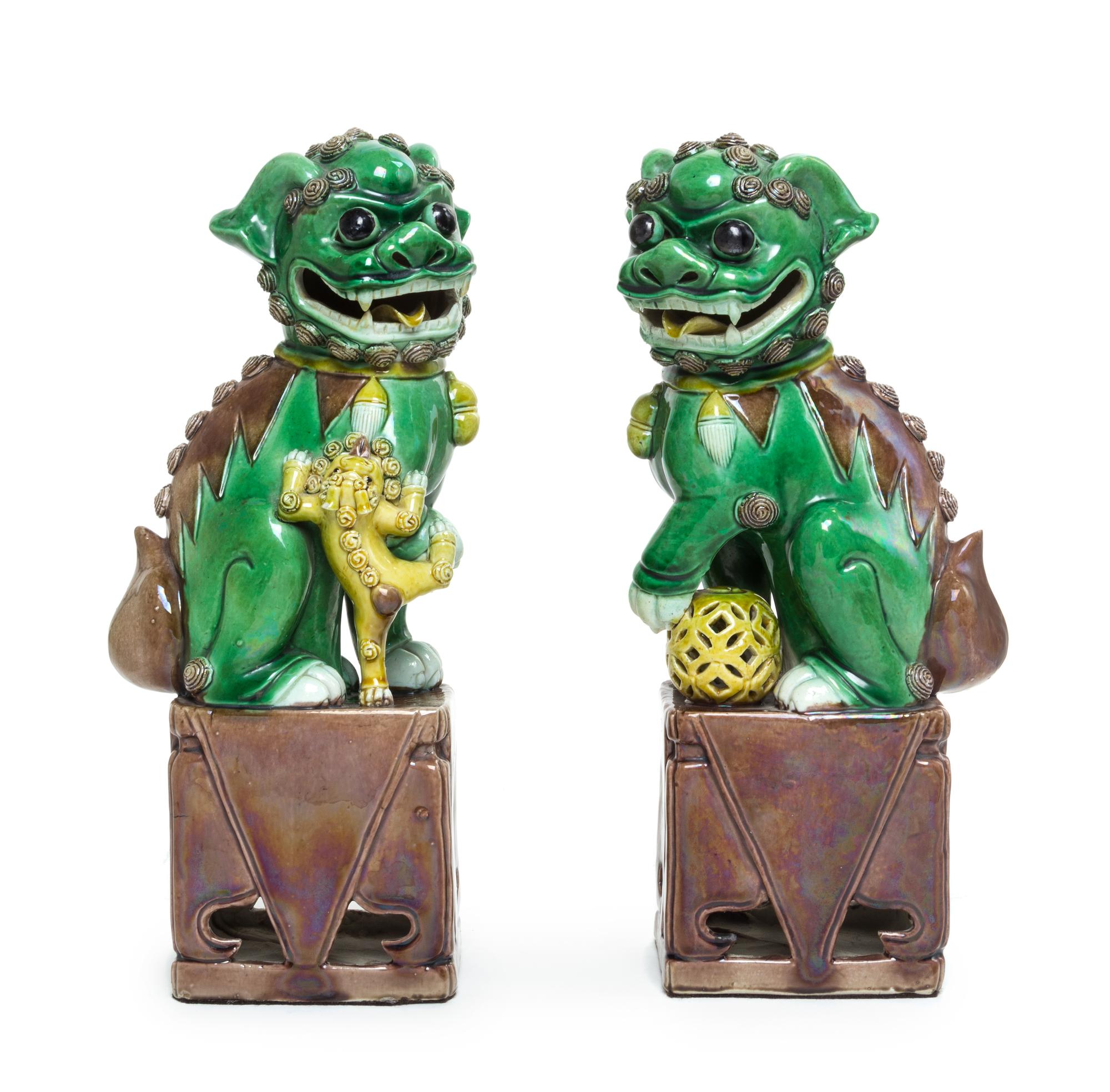 A Pair of Sancai Glazed Porcelain Figure of Fu Lions Height of each 11 3/4 inches. — 19TH CENTURY
