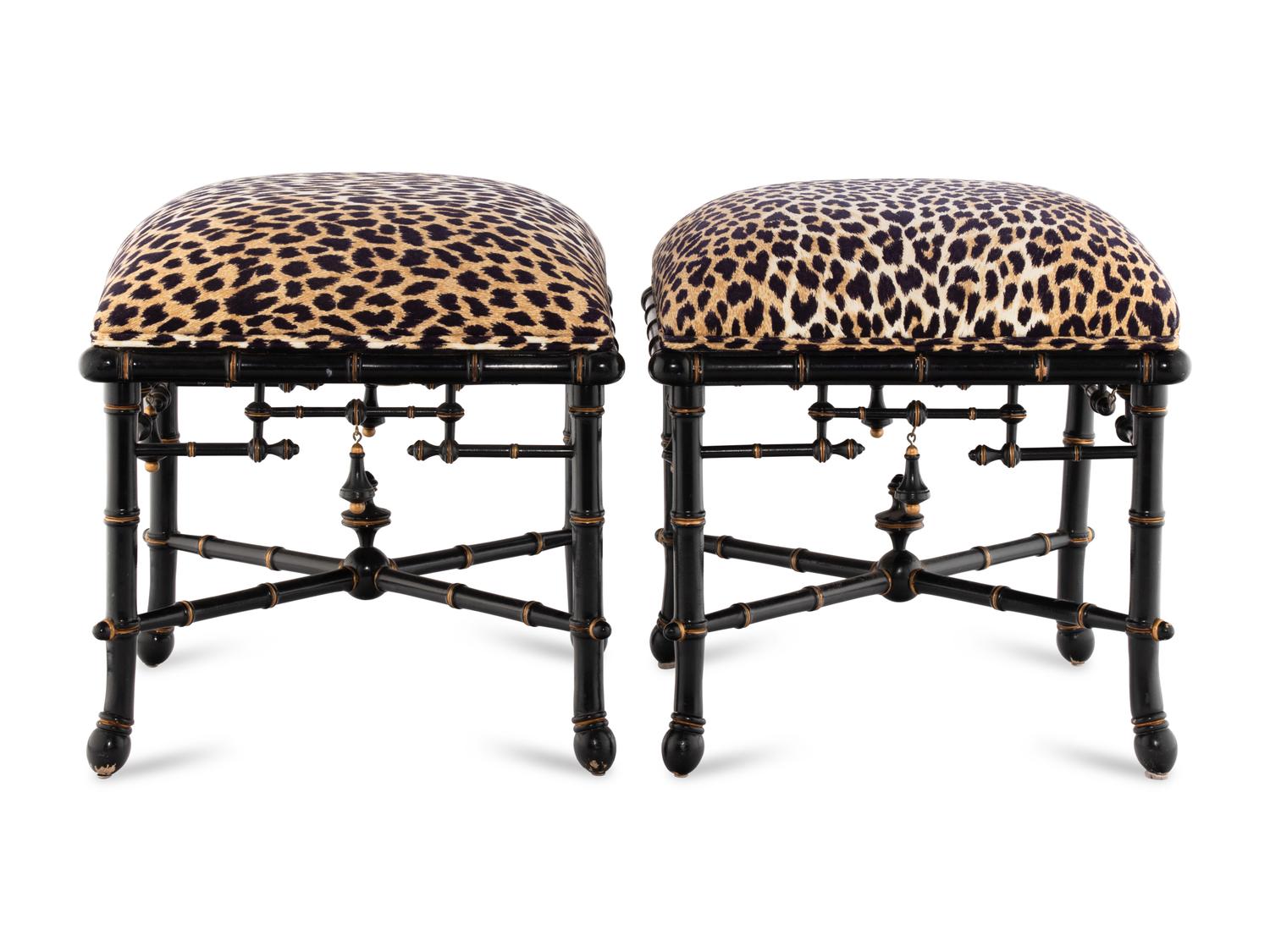 A Pair of Baker Upholstered and Ebonized Faux-Bamboo Footstools