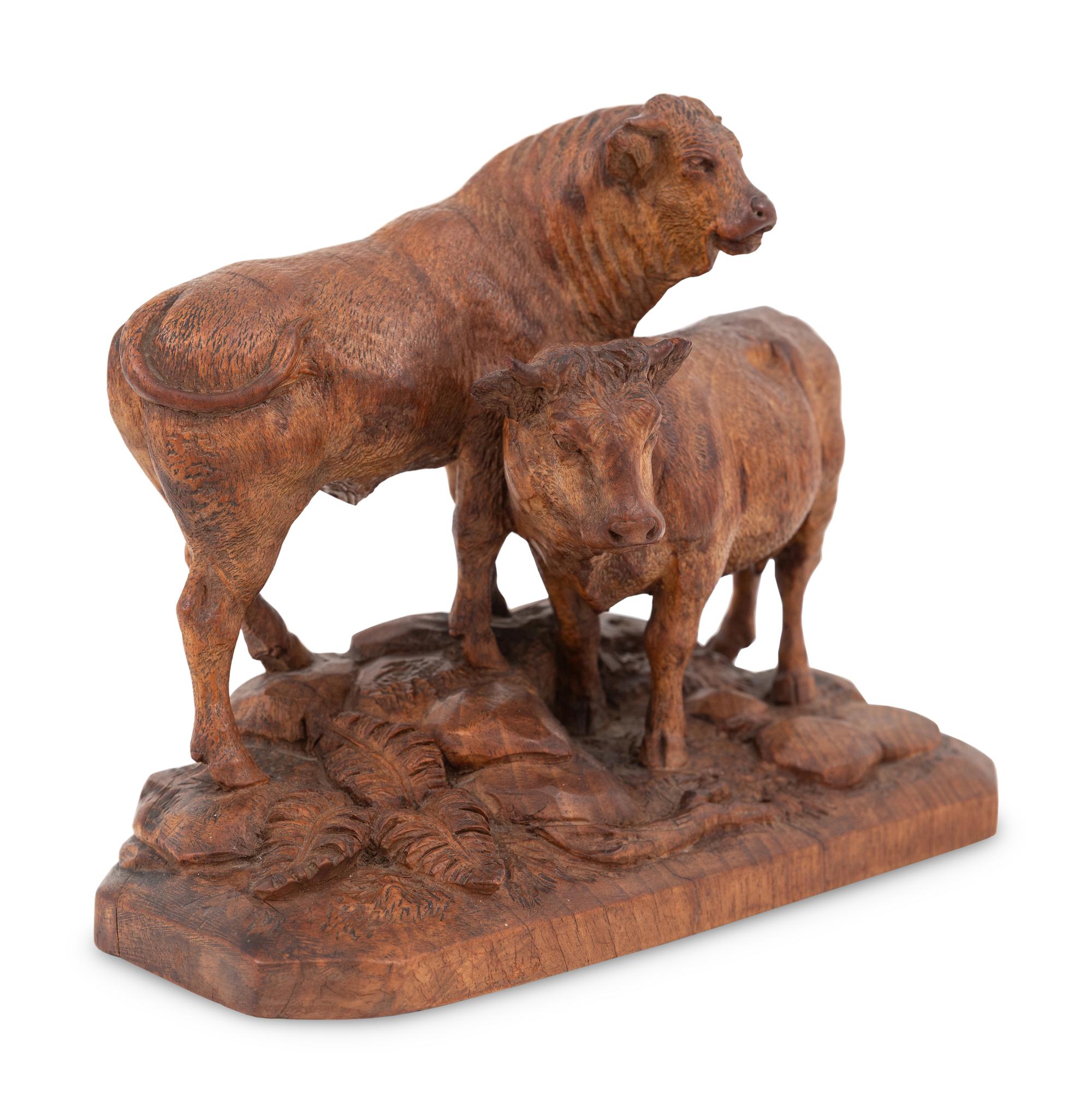 A Swiss Black Forest Carved Bull and Cow Group
