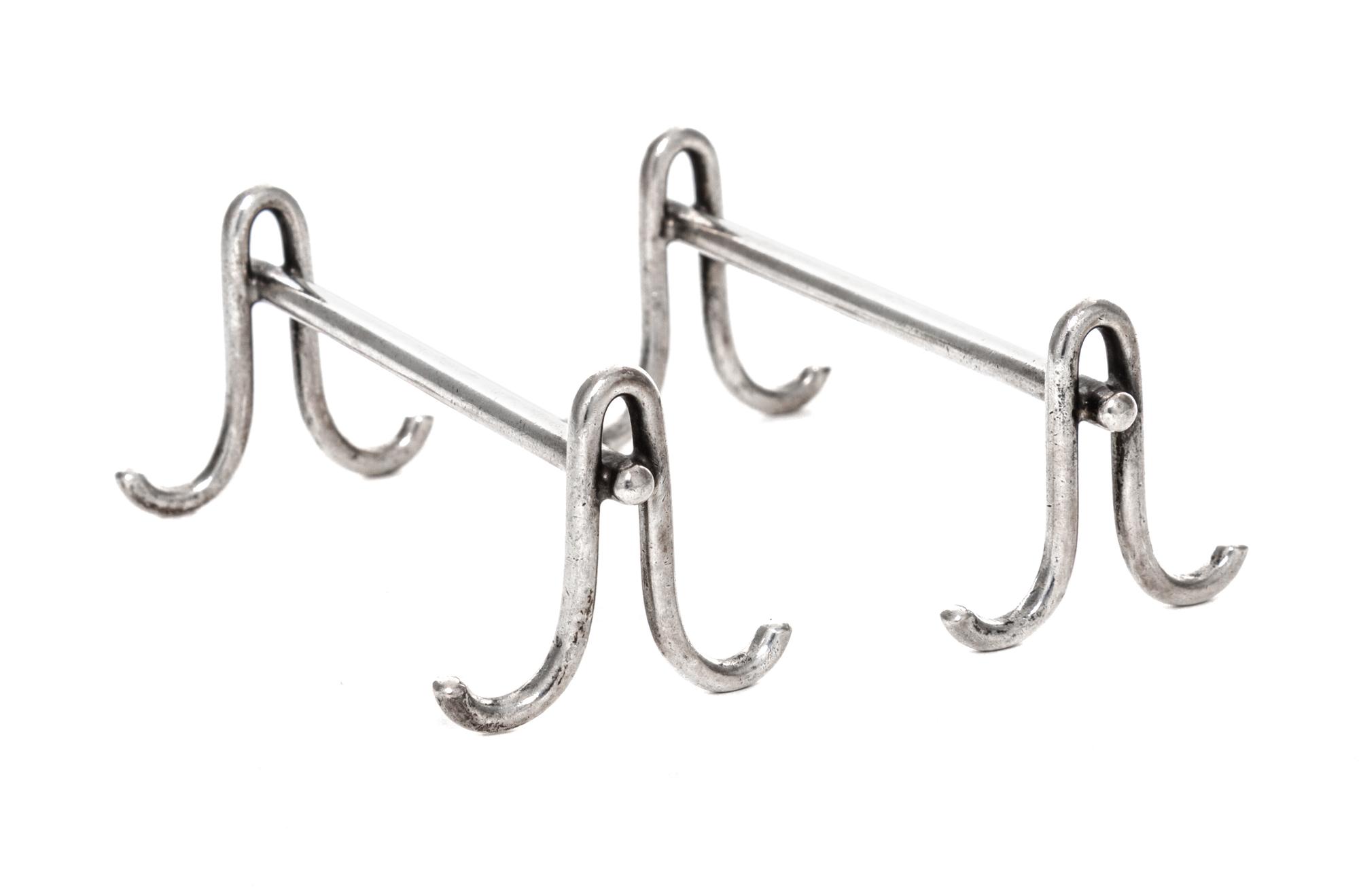 A Pair of American Silver Knife Rests, Gorham Mfg. Co., Providence, RI, each raised on two shaped supports