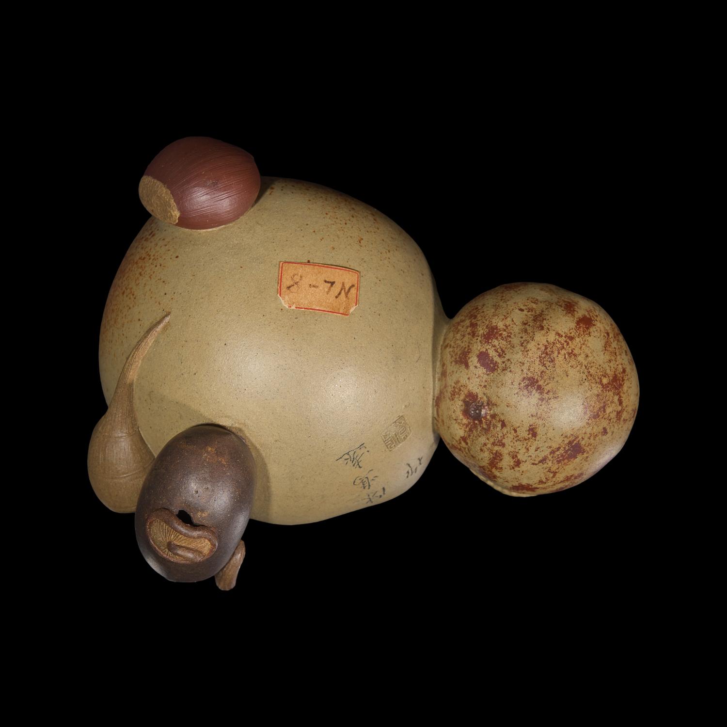 A Rare Chinese Yixing 'Peach and Pomegranate' Coupe Inscribed 'Chen Minyuan Zuo' and Carved Wood Stand 陳鳴遠款段泥紫砂桃榴杯