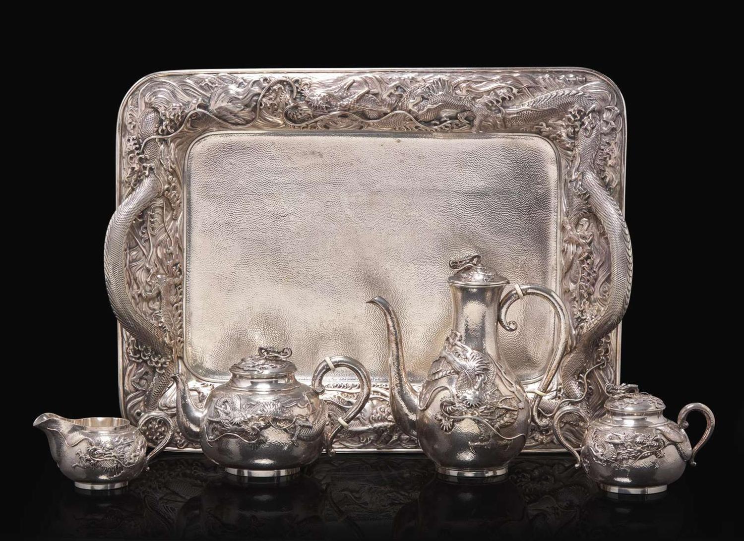 An impressive Japanese export silver four-piece "Dragon" tea and coffee service with tray, retailed by Arthur & Bond, Yokohama, late 19th/early 20th century 日式銀質咖啡器茶具四件及托盤 十九世紀末或二十世紀初