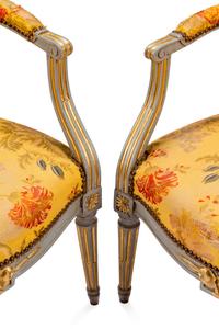 A Pair of Louis XVI Painted and Parcel Gilt Fauteuils