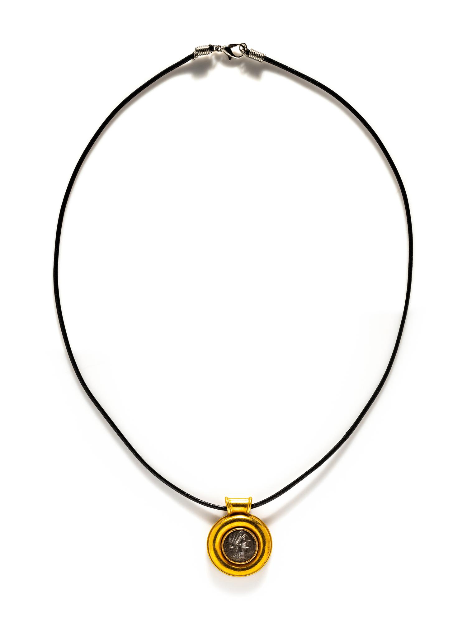 A Greek Silver Coin — Set in a gold pendant