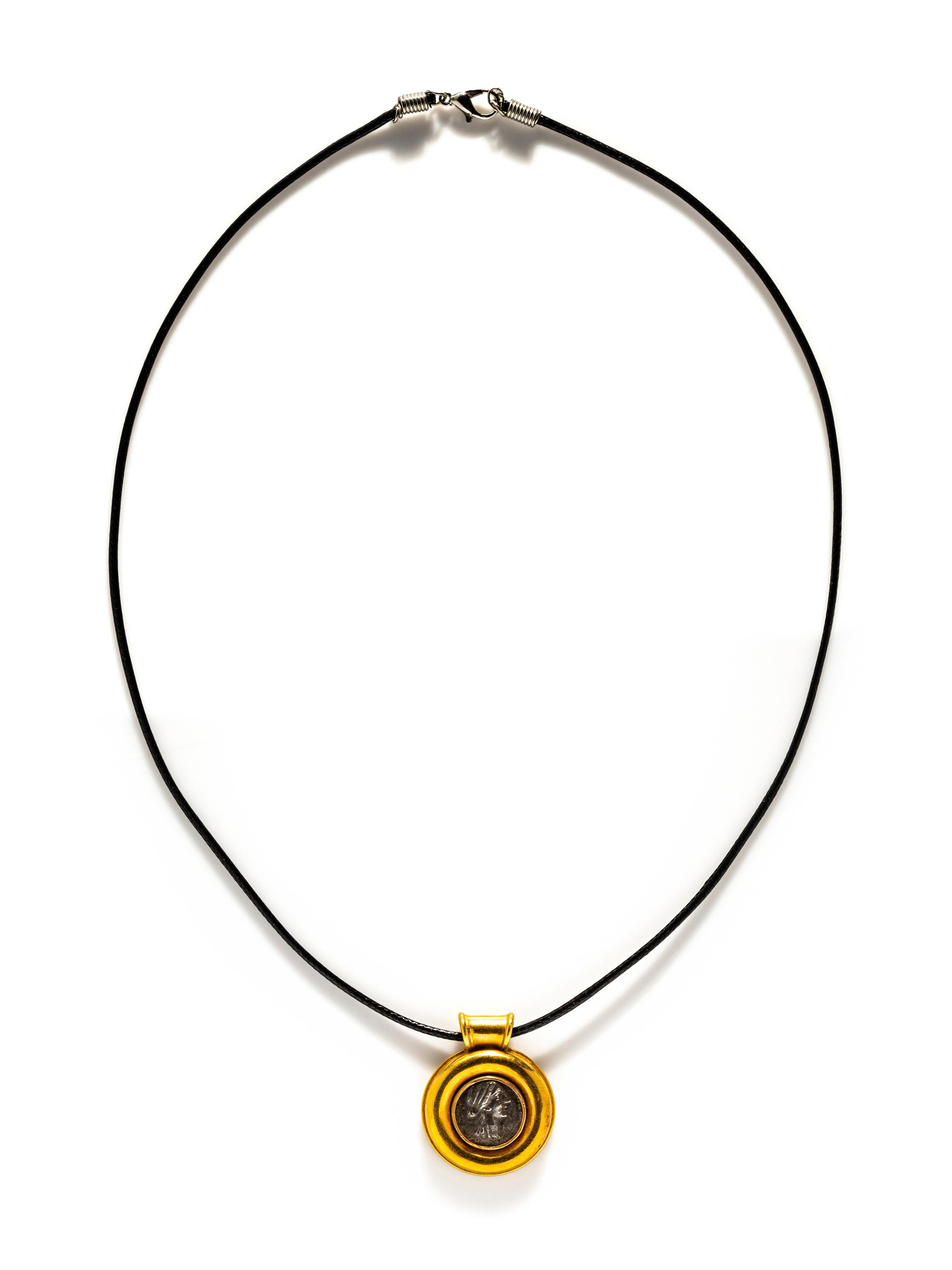 A Greek Silver Coin — Set in a gold pendant