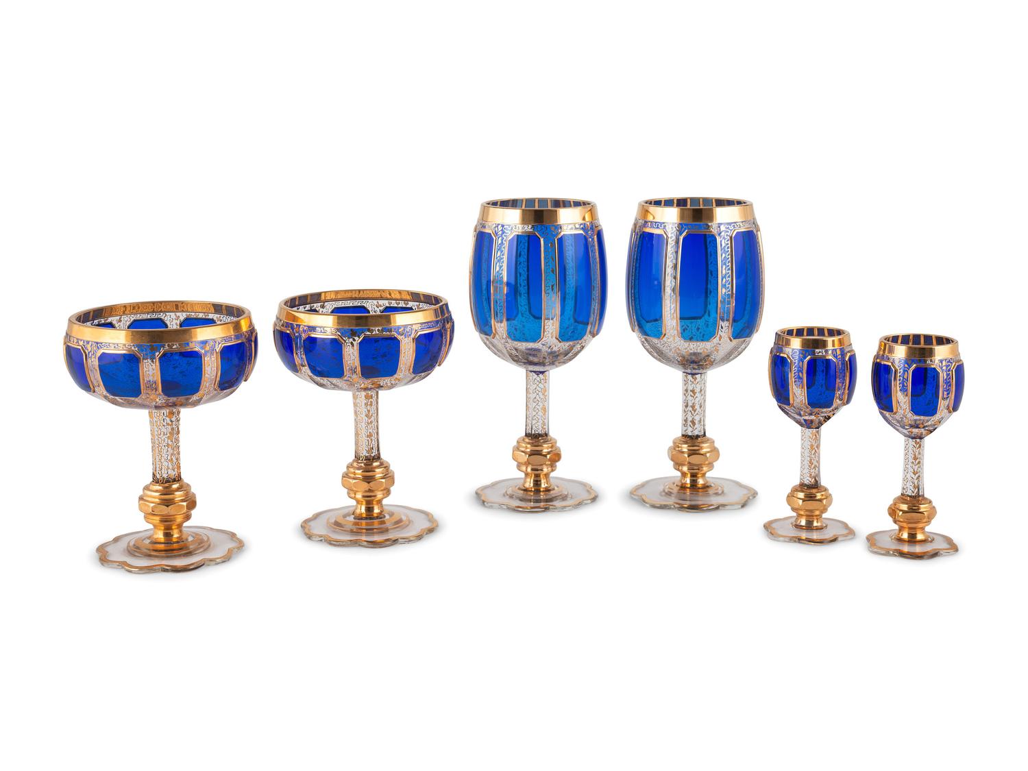 Twenty-Six Cobalt and Clear Glass Parcel Gilt Stemware Articles