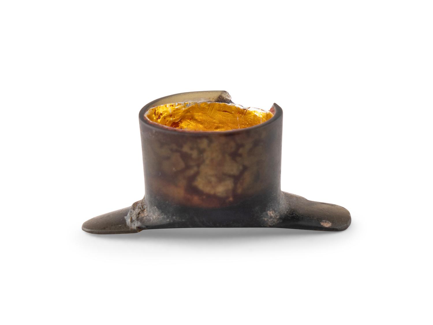 An Aztec Gold-Gilt Obsidian Labret