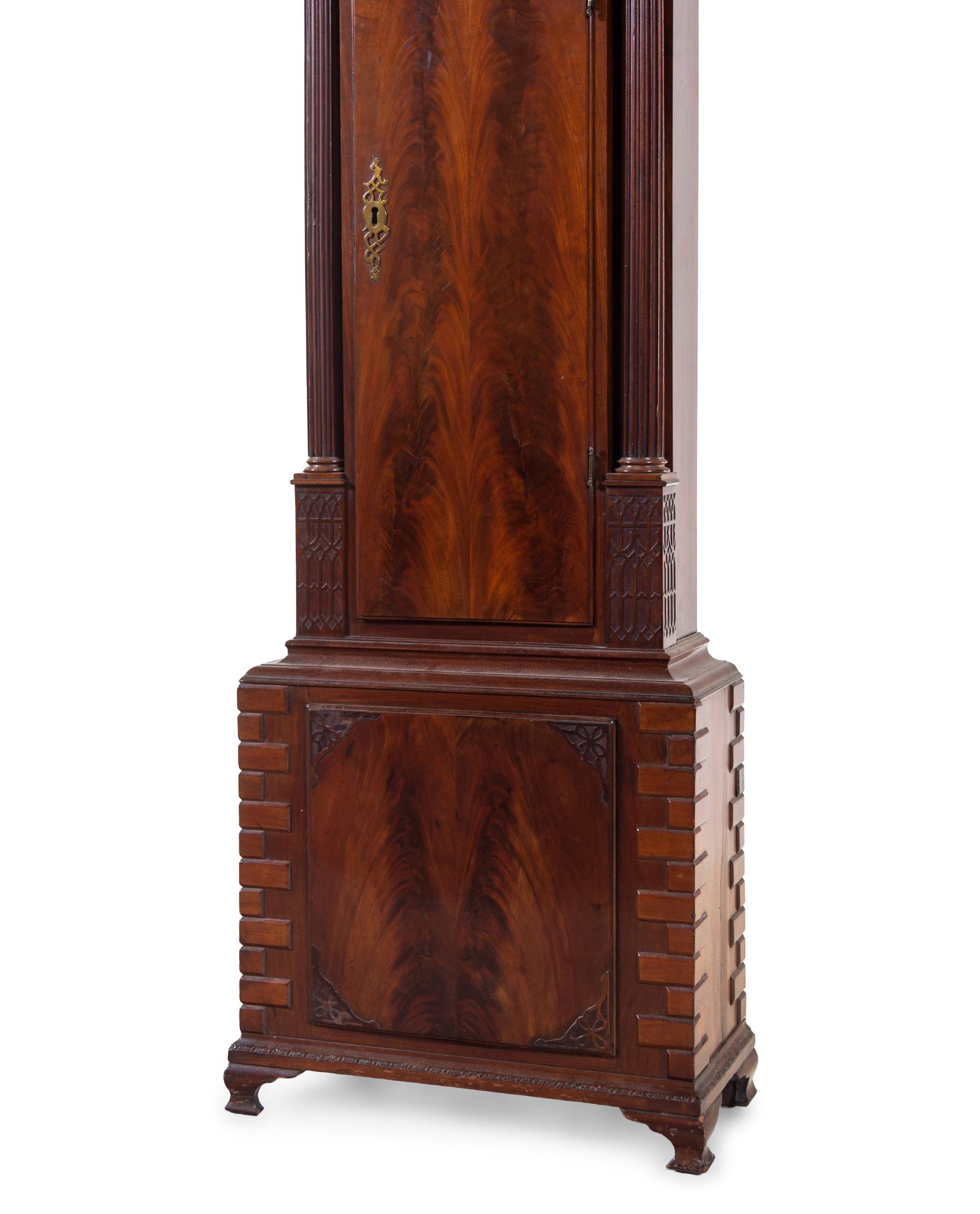 A George III Carved and Figured Mahogany Tall Case Clock