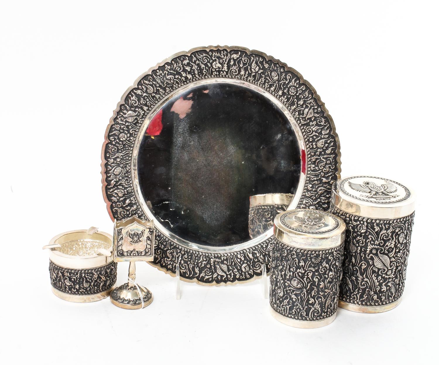 A Silver Mounted Smoking Set, , comprising a circular tray, ash receiver, match holder, tobacco jar and cigarette jar, all contained in