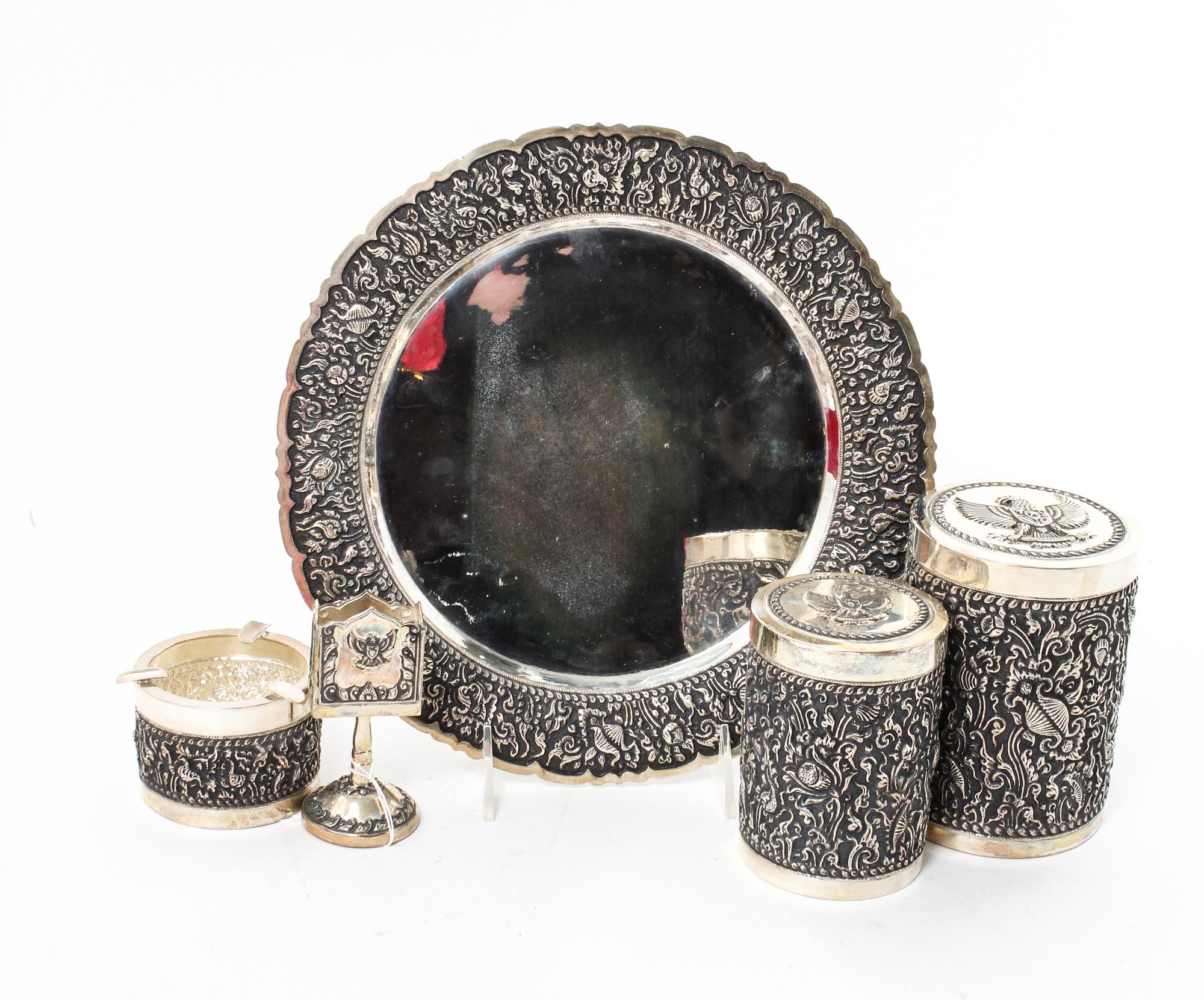 A Silver Mounted Smoking Set, , comprising a circular tray, ash receiver, match holder, tobacco jar and cigarette jar, all contained in
