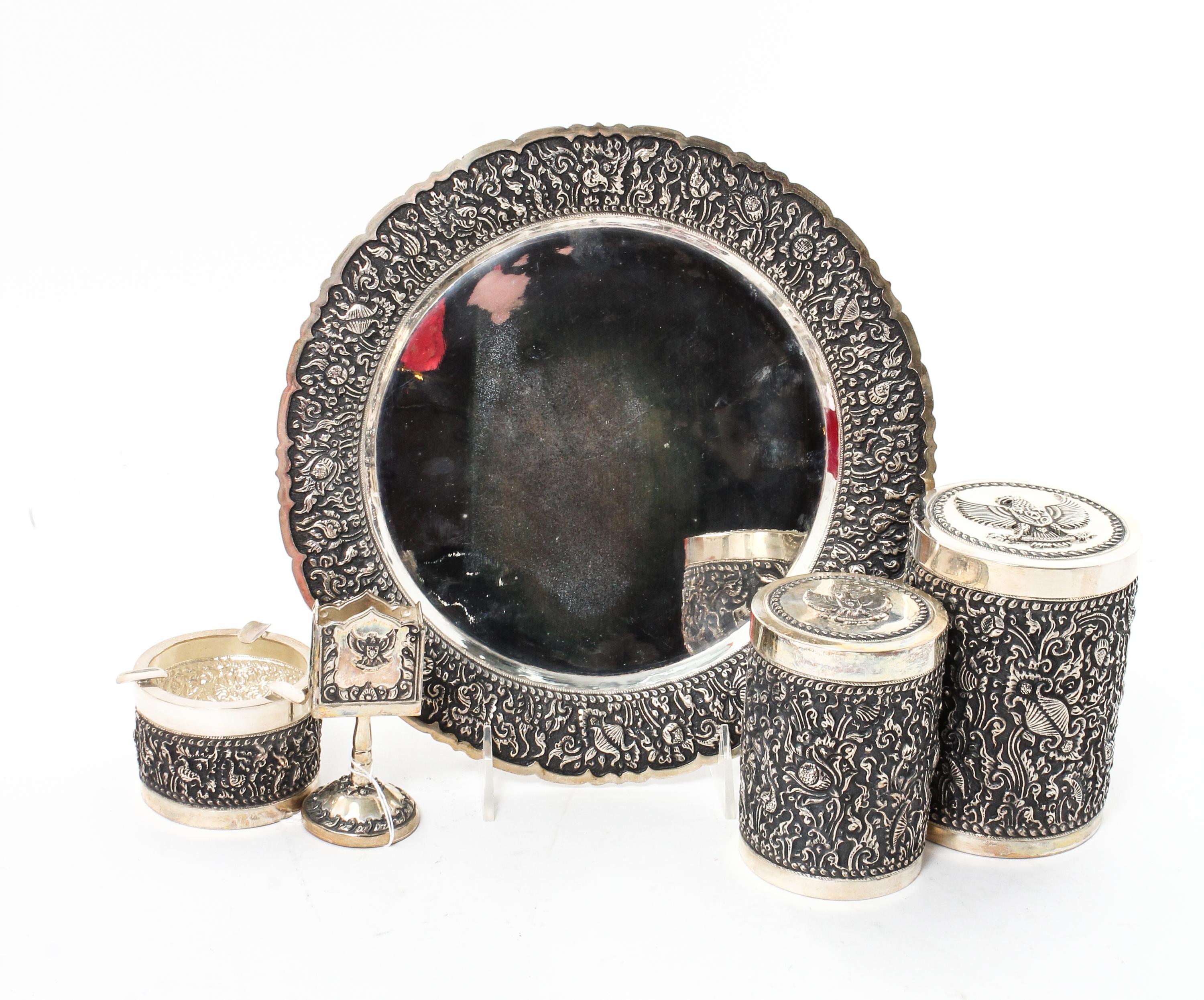 A Silver Mounted Smoking Set, , comprising a circular tray, ash receiver, match holder, tobacco jar and cigarette jar, all contained in