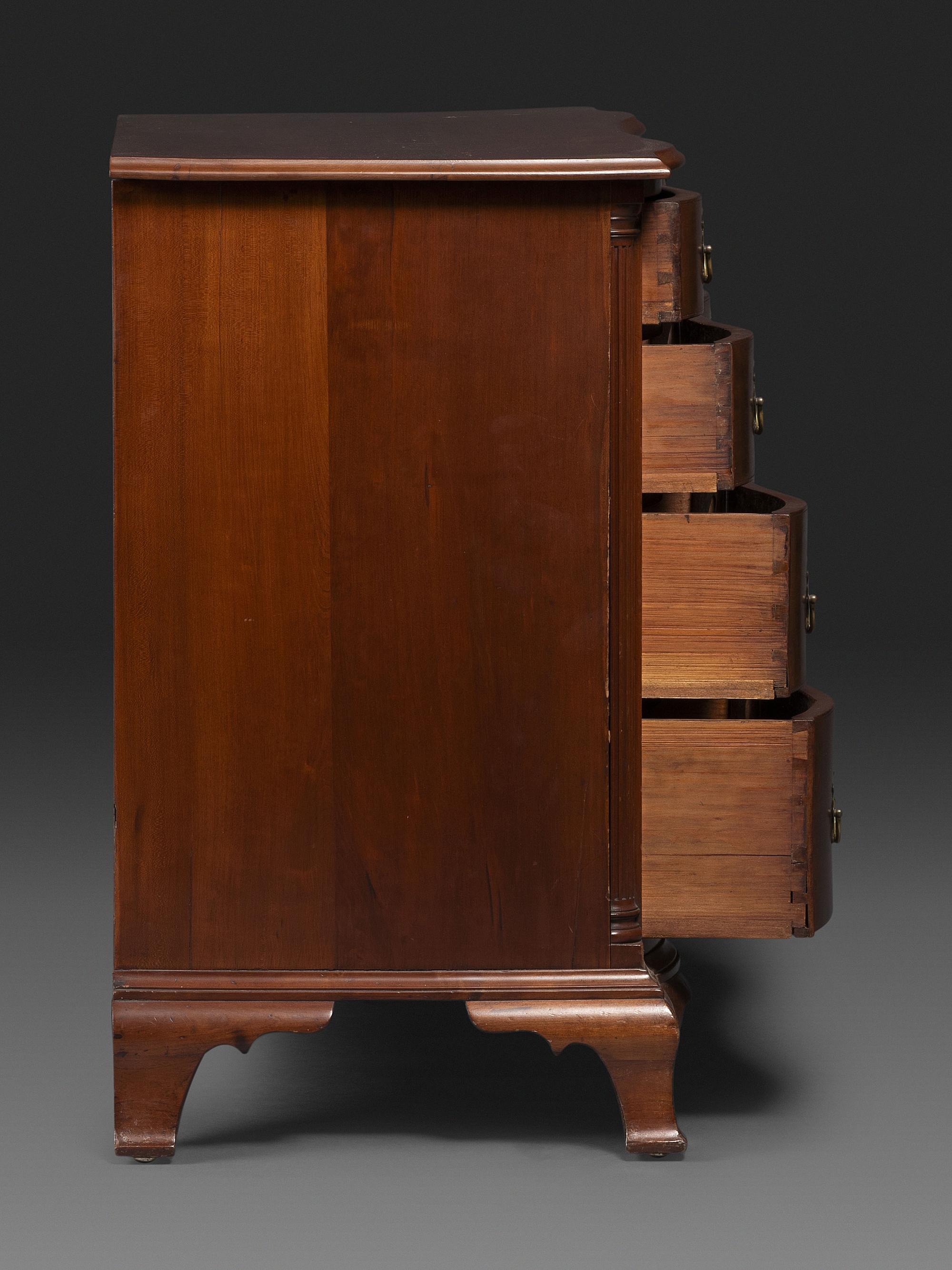 A Chippendale Carved Cherrywood Reverse-Serpentine Chest of Drawers