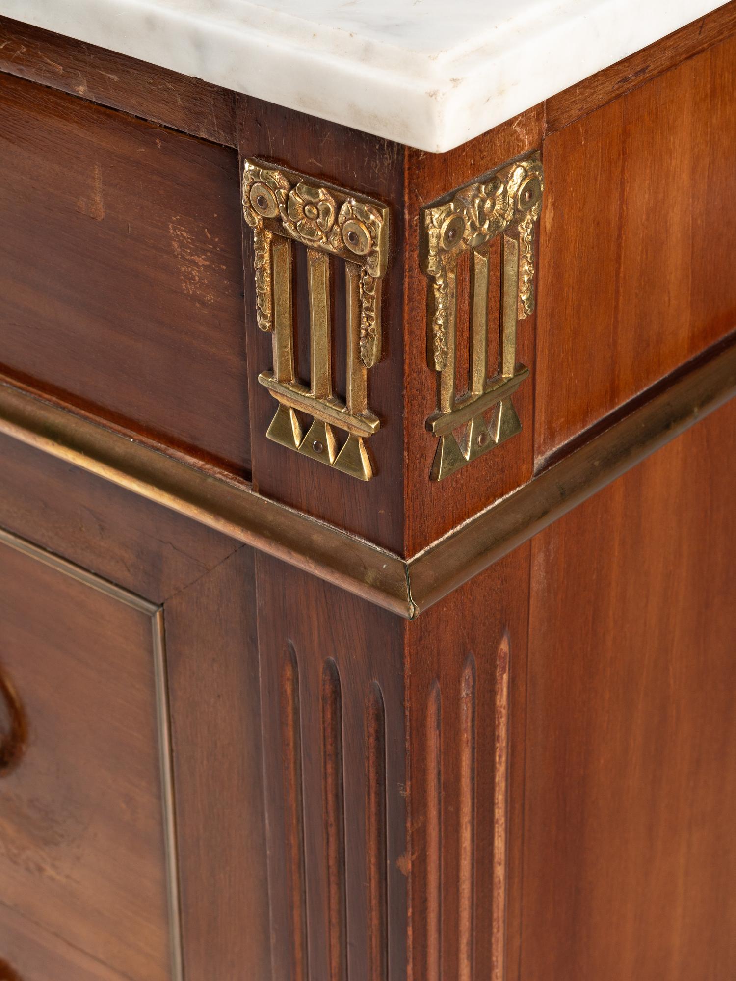 A Louis XVI Style Gilt Bronze Mounted Mahogany Marble-Top Commode