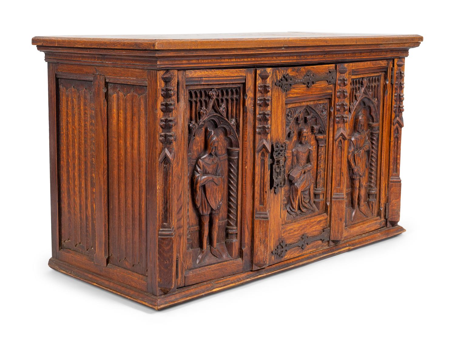 A Renaissance Revival Carved Oak Trunk with Iron Mounts — 19TH/20TH CENTURY