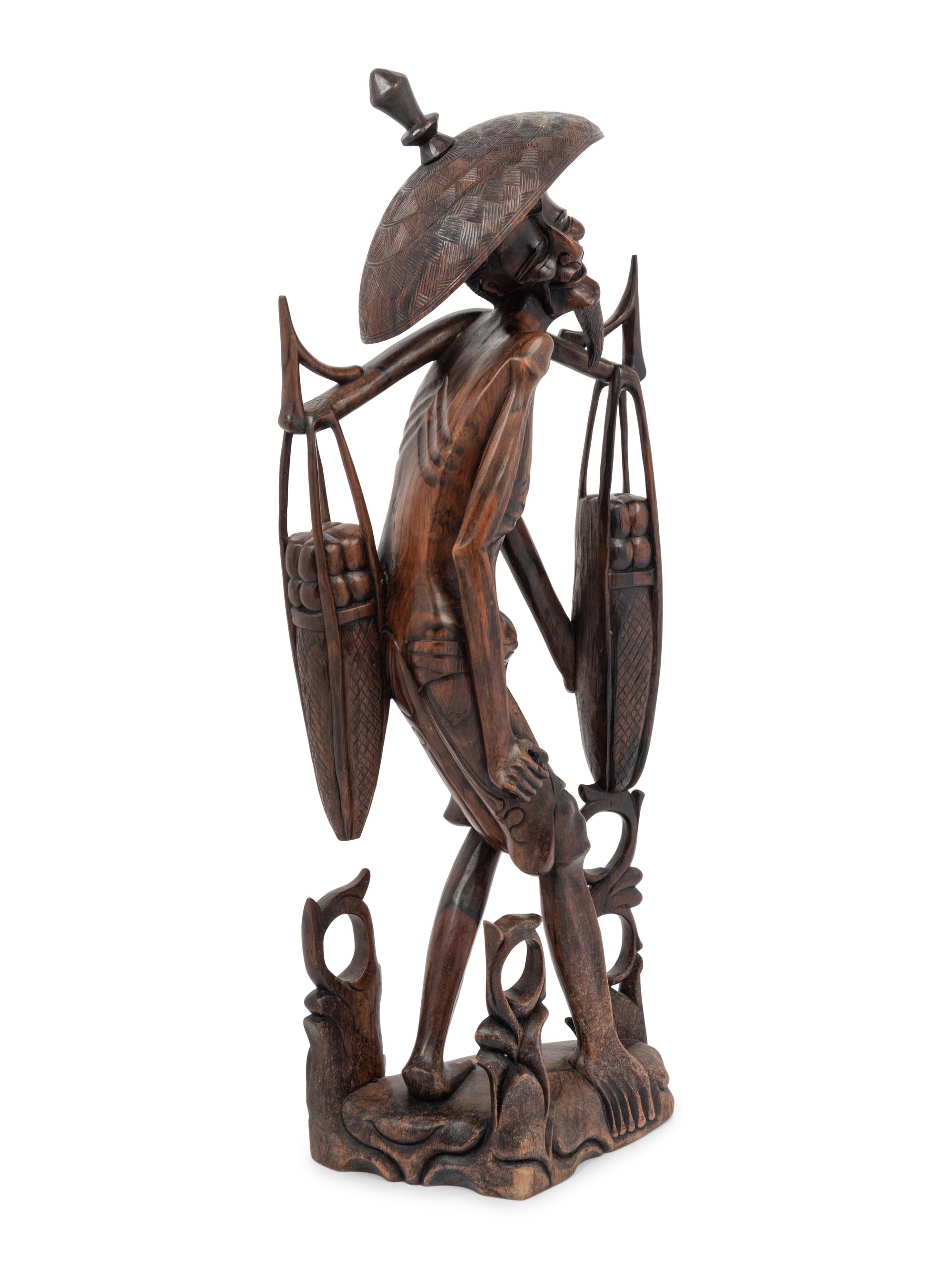 A Carved Wood Figure of a Water Carrier