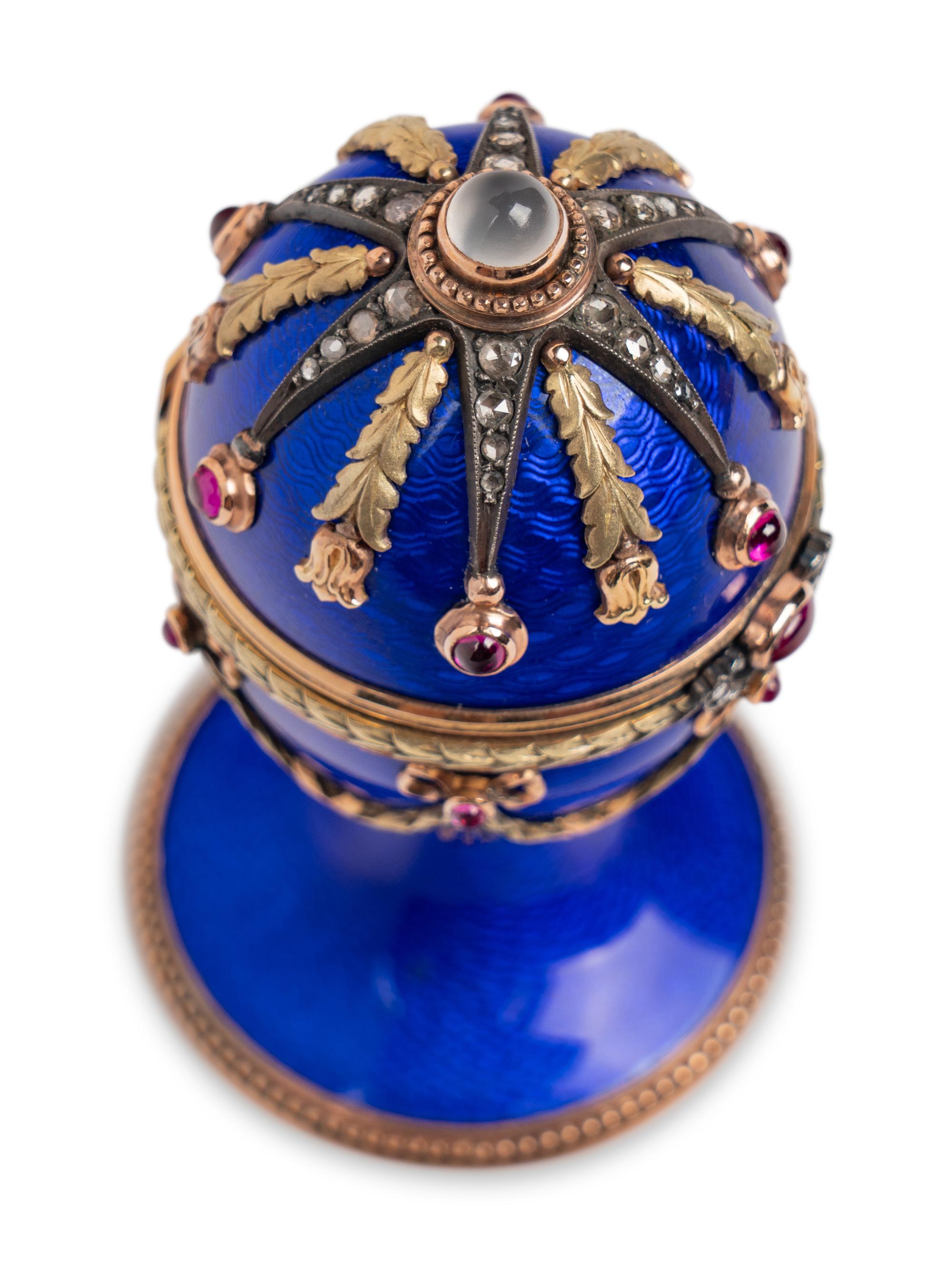 A 14 Karat Vari-Color Gold, Guilloché Enamel, Diamond, and Cabochon Jewel-Mounted Egg-Form Perfume and a Related Guilloché Enamel, 14 Karat Vari-Color Gold, Diamond, and Cabochon-Mounted Surprise Egg