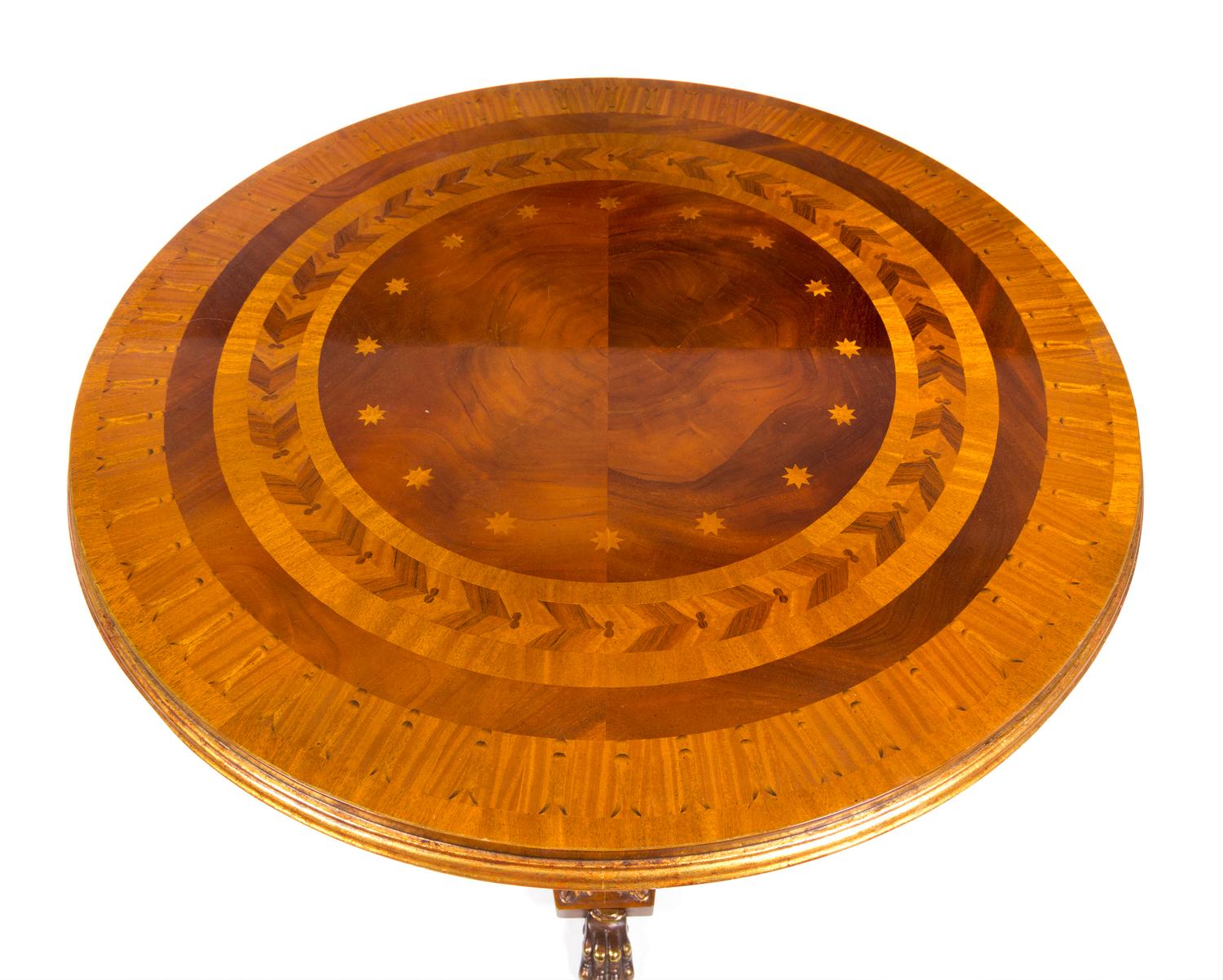 A Regency Style Parcel Gilt Satinwood and Marquetry Table Height 30 x diameter of top 34 1/2 inches. — 20TH CENTURY