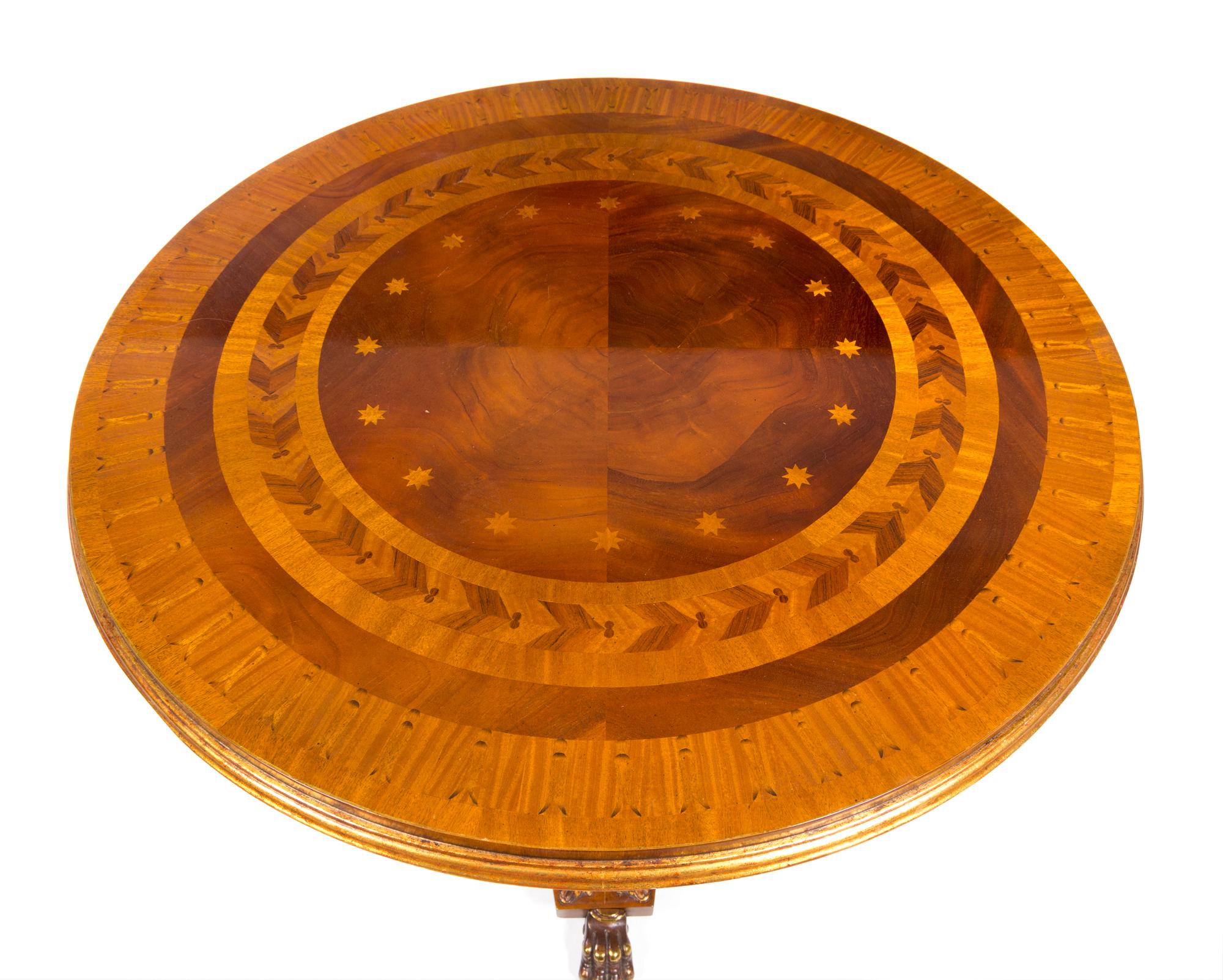 A Regency Style Parcel Gilt Satinwood and Marquetry Table Height 30 x diameter of top 34 1/2 inches. — 20TH CENTURY