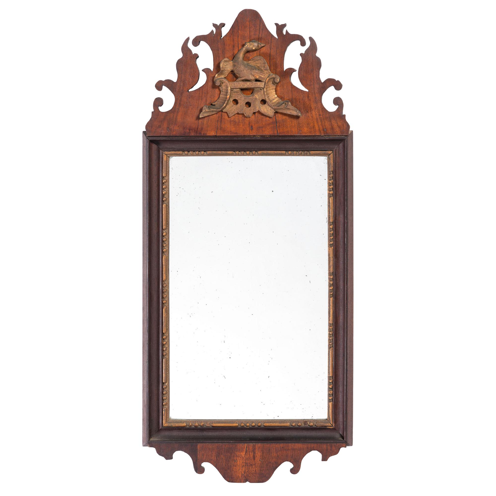 A Chippendale Parcel Gilt and Carved Mahogany Eagle Decorated Looking Glass