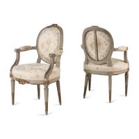 A Pair of Louis XVI Style Gray-Painted and Parcel-Gilt Armchairs