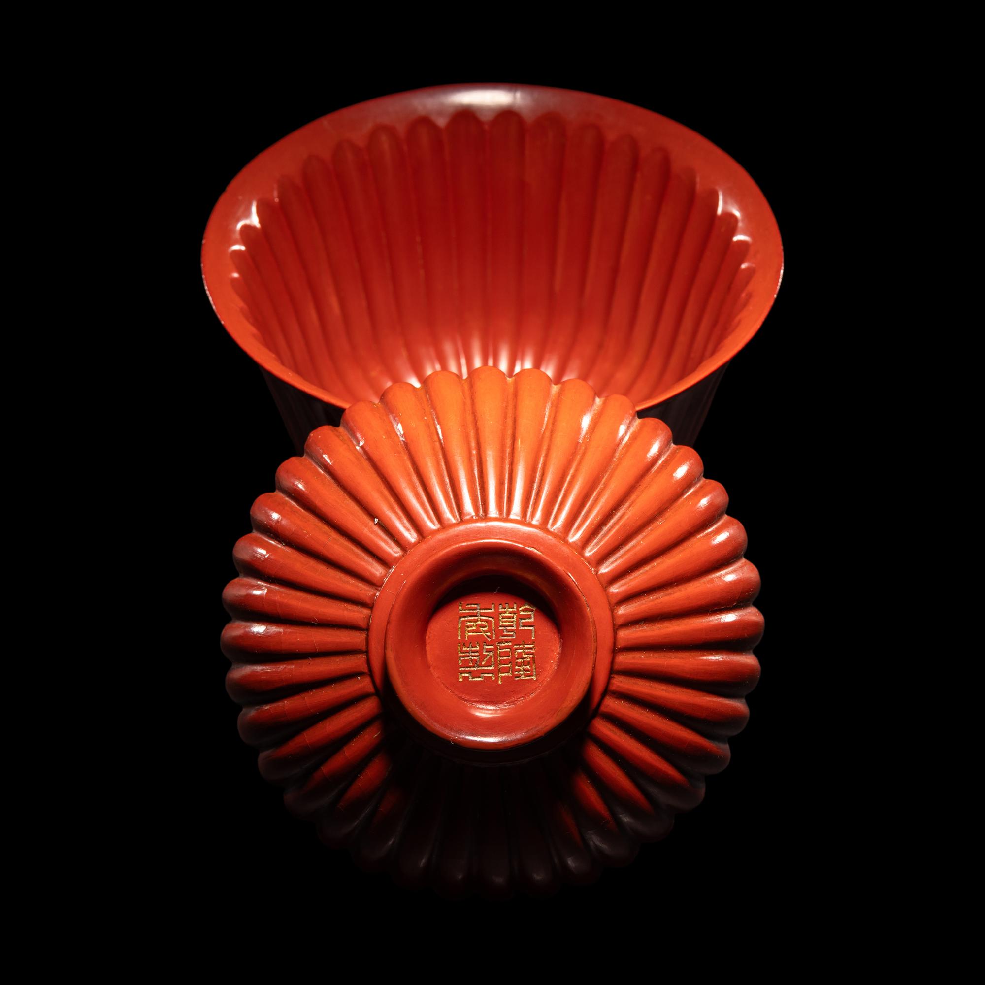 A Fine Red Lacquer Inscribed 'Chrysanthemum' Tea Bowl and Cover, Qianlong Mark 乾隆年製款 朱漆御題詩菊瓣式蓋碗
