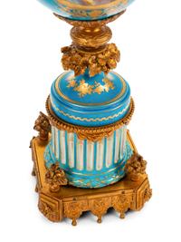 A Pair of Sèvres Style Gilt Bronze Mounted Porcelain Urns