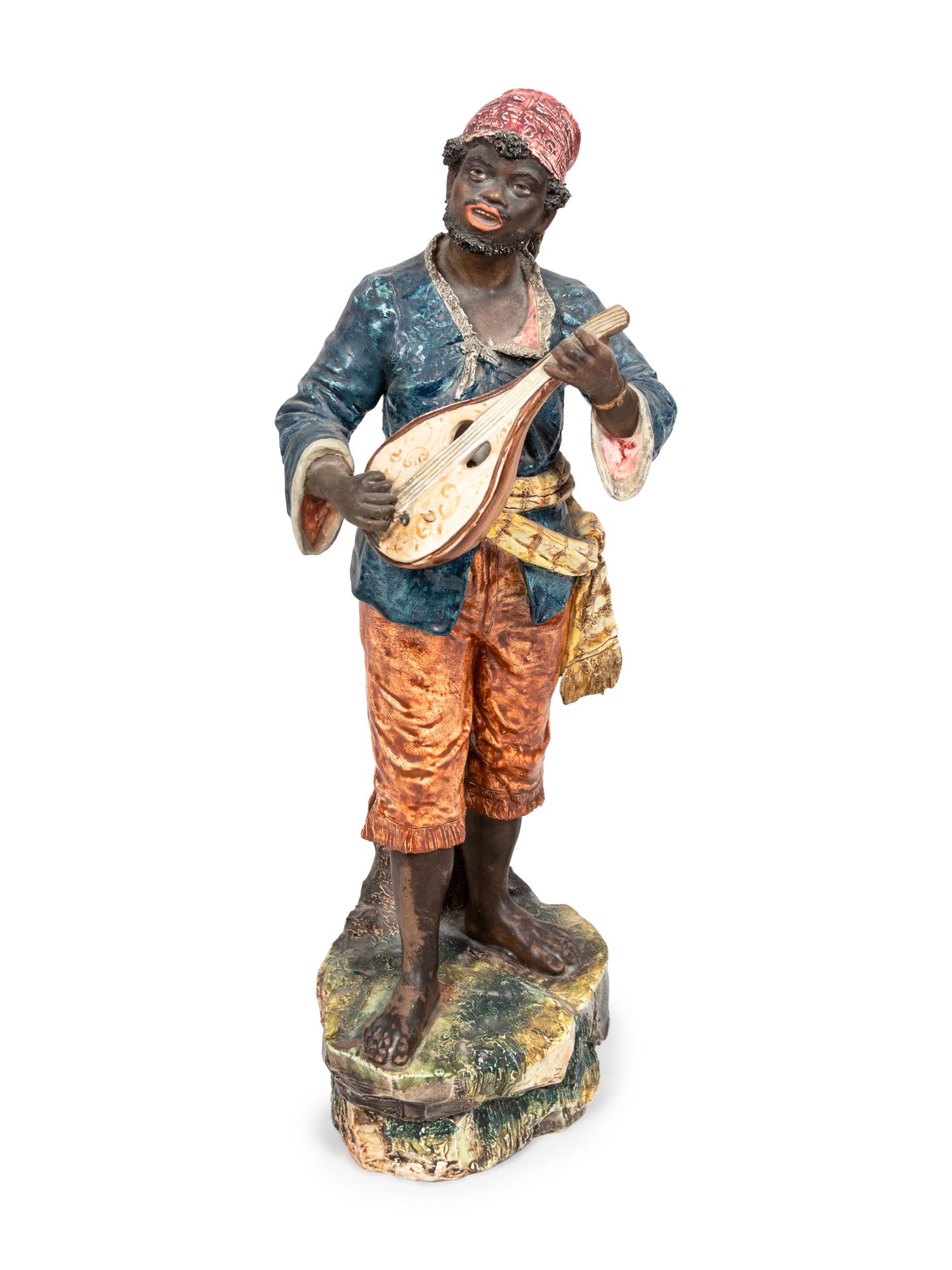 A Glazed Ceramic Figure of a Musician