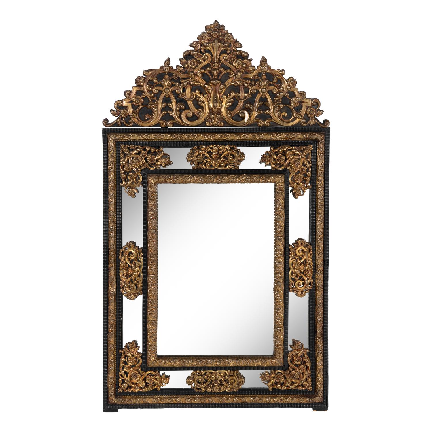 A Baroque Style Gilt Metal Mounted Ebonized Mirror
