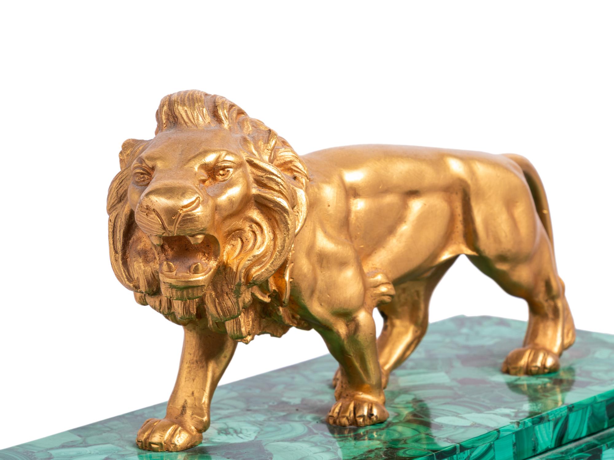 An Empire Style Gilt Metal and Malachite Veneered “Crystal Regulator" Clock