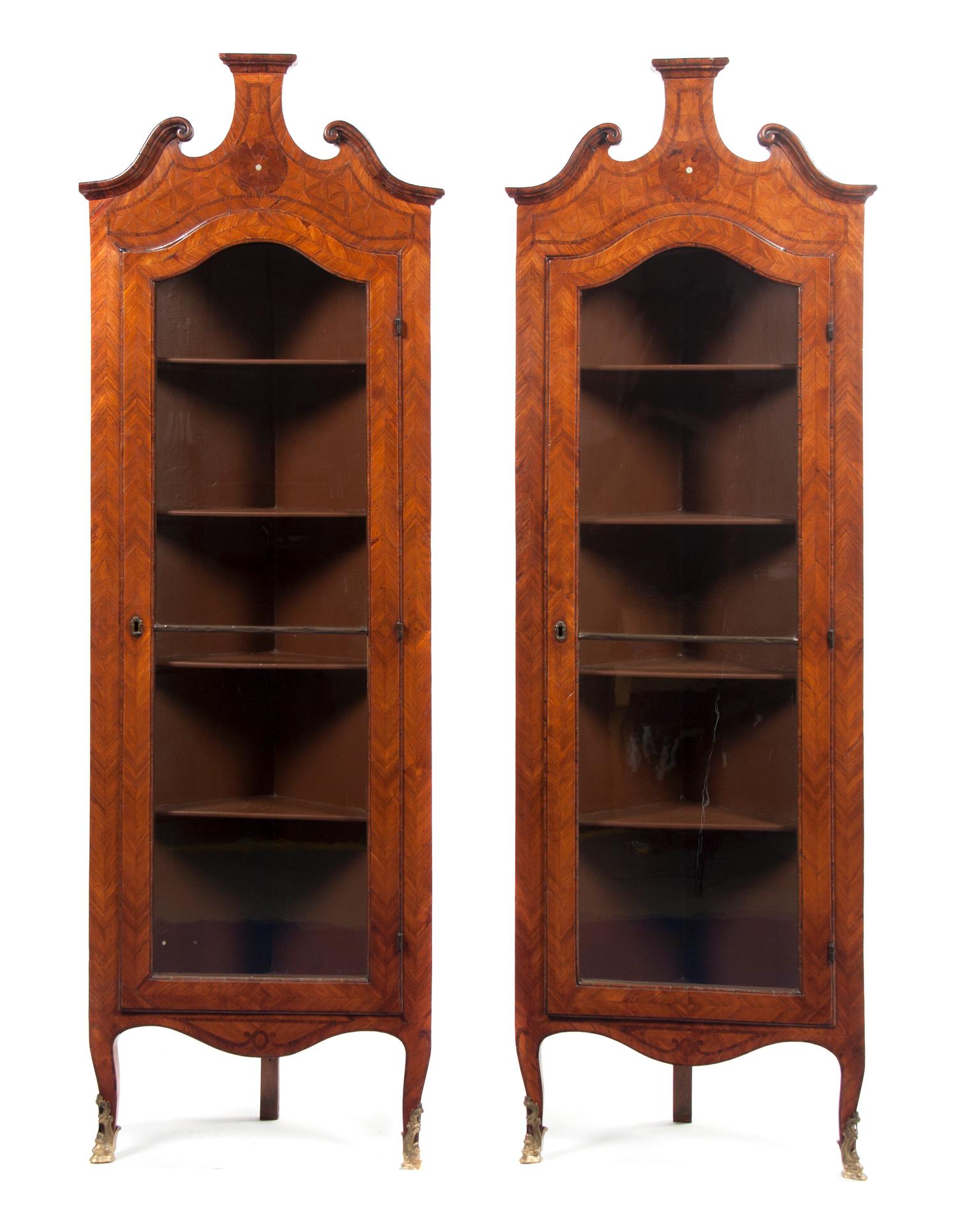 A Pair of Continental Parquetry Corner Cabinets, Height 75 1/2 x width 24 7/8 x depth 13 1/8 inches.