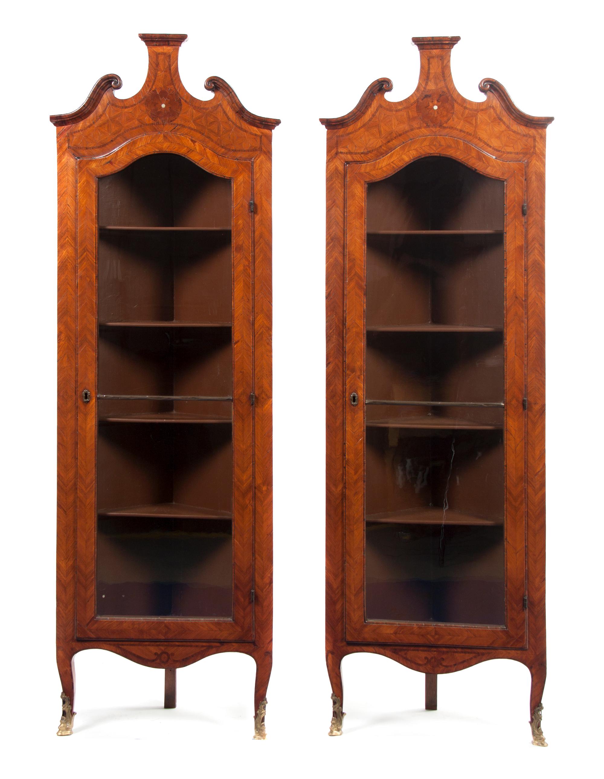 A Pair of Continental Parquetry Corner Cabinets, Height 75 1/2 x width 24 7/8 x depth 13 1/8 inches.