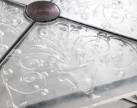 An Etched Glass-Top Patinated Metal Cocktail Table