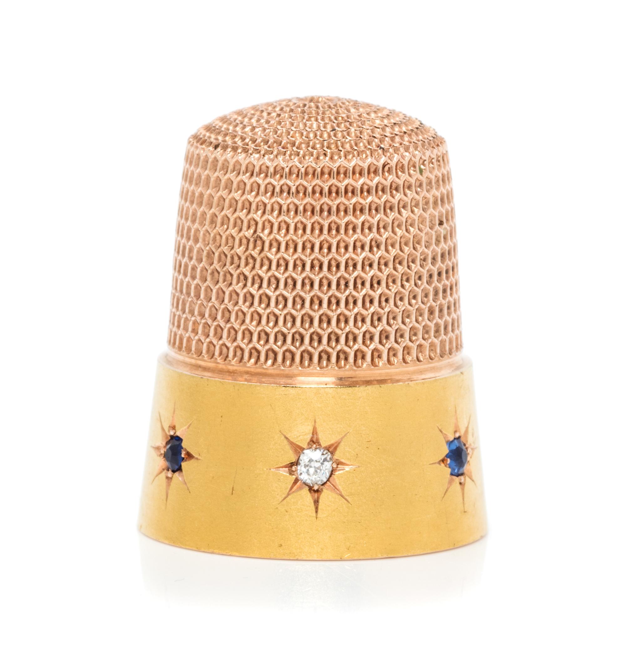 An American 14-Karat Gold, Diamond and Sapphire Thimble, Simons Bros., Philadelphia, PA, the dimpled top and body above a plain band wo