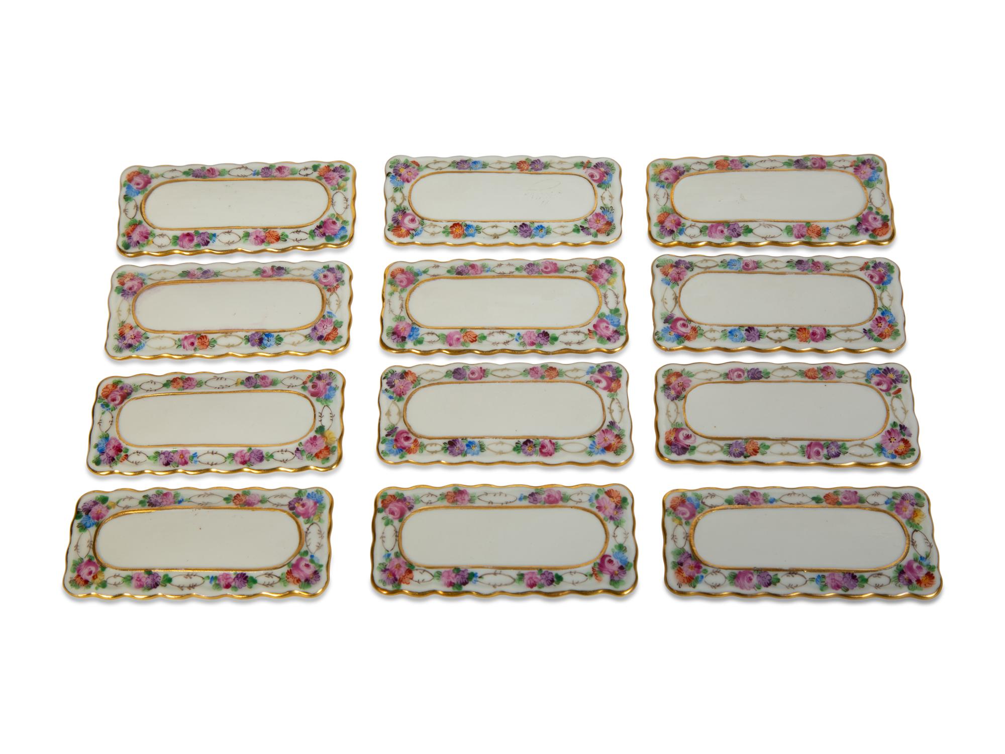 A Collection of Dresden Porcelain Place Cards, Holders and Napkin Rings