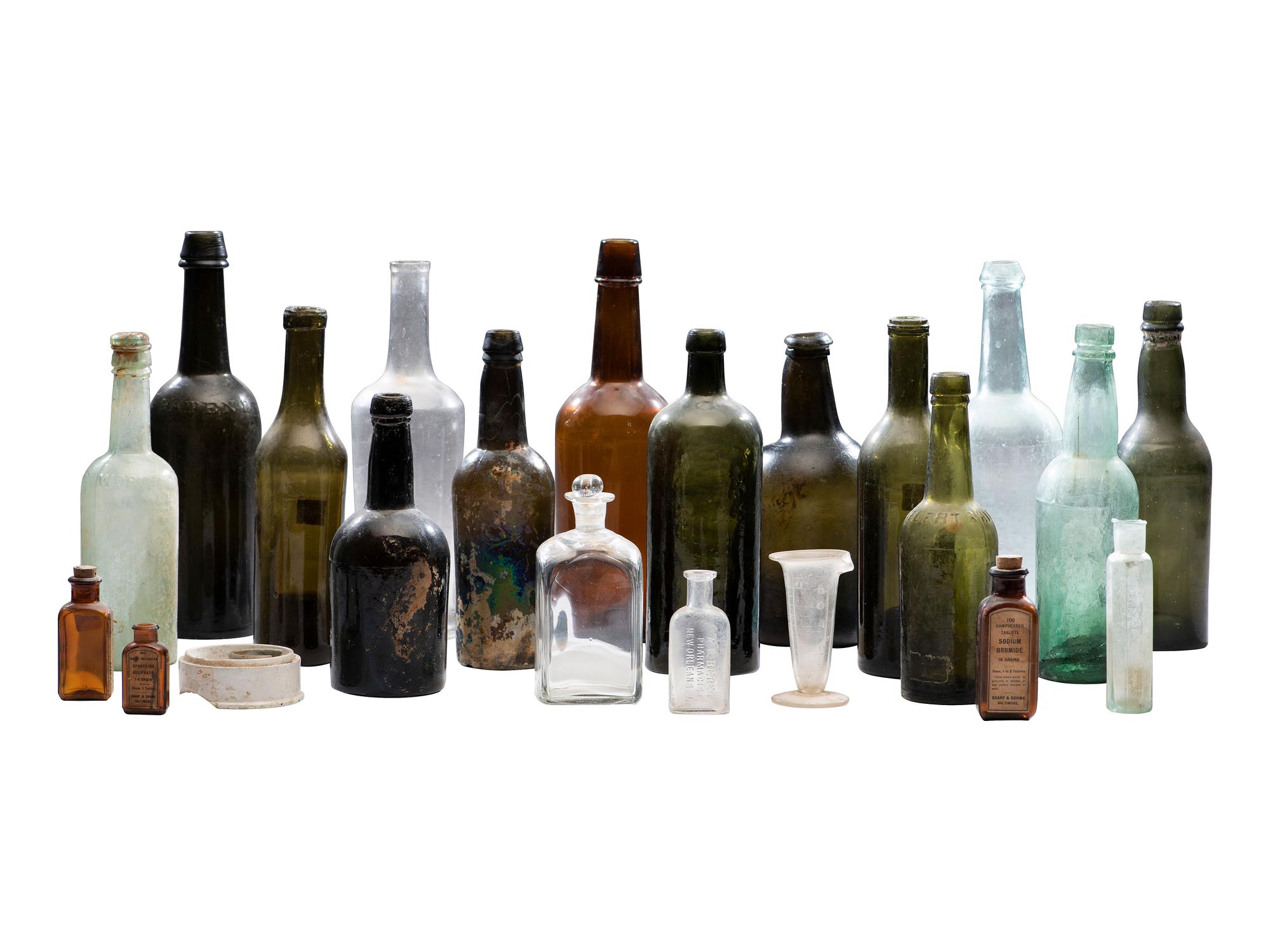 [AMERICANA]. Assembled collection of American glass and ceramic liquor and utility bottles.