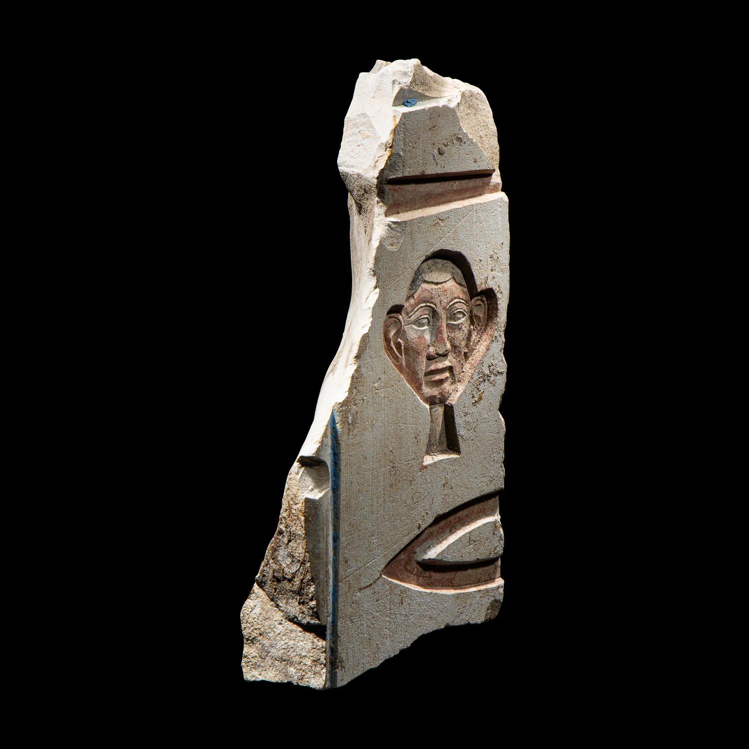 An Egyptian Painted Limestone Relief Fragment
