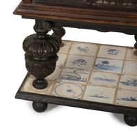 A Gothic Revival Carved Oak Tile-Mounted Chest on Stand