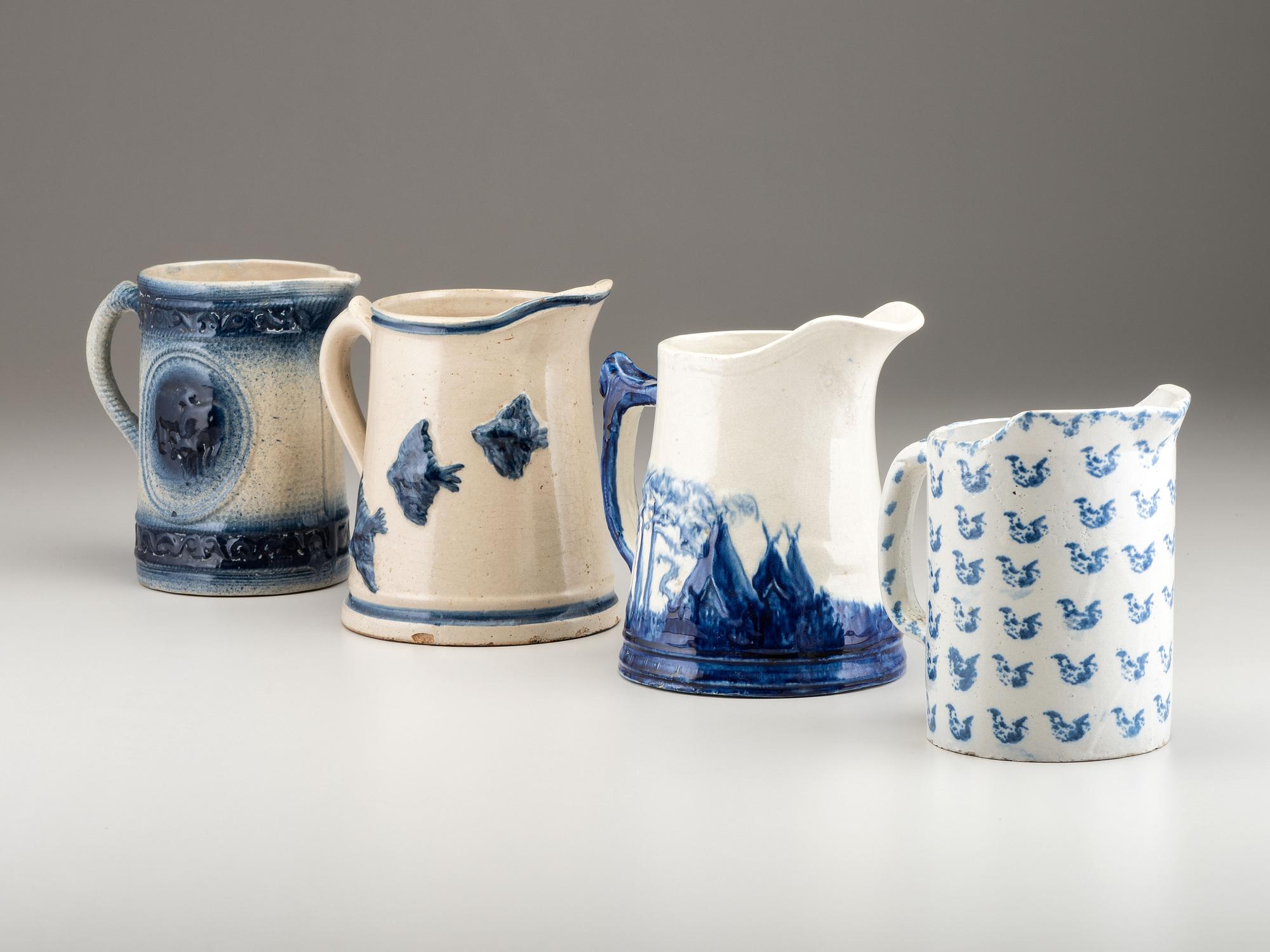 Four Cobalt Decorated Molded Stoneware Pitchers