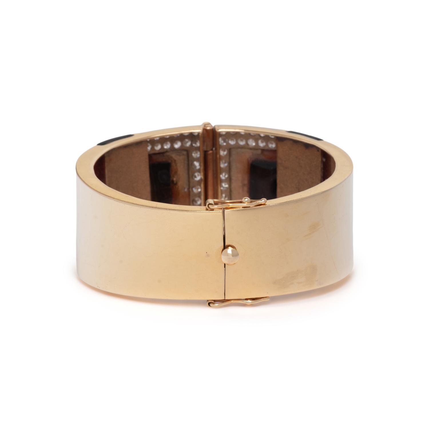 YELLOW GOLD, ONYX, AND DIAMOND HINGED BANGLE BRACELET