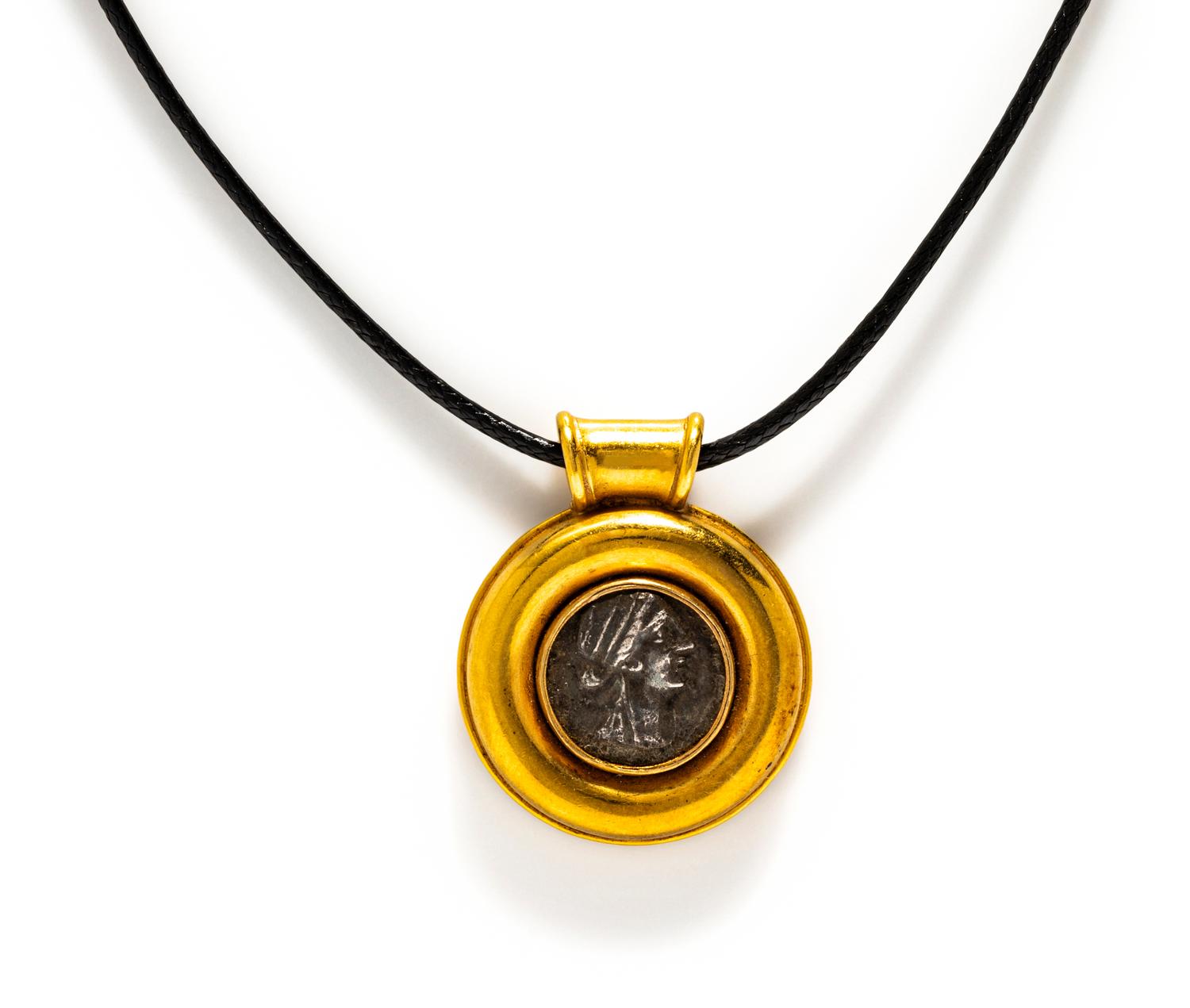A Greek Silver Coin — Set in a gold pendant