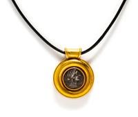 A Greek Silver Coin — Set in a gold pendant