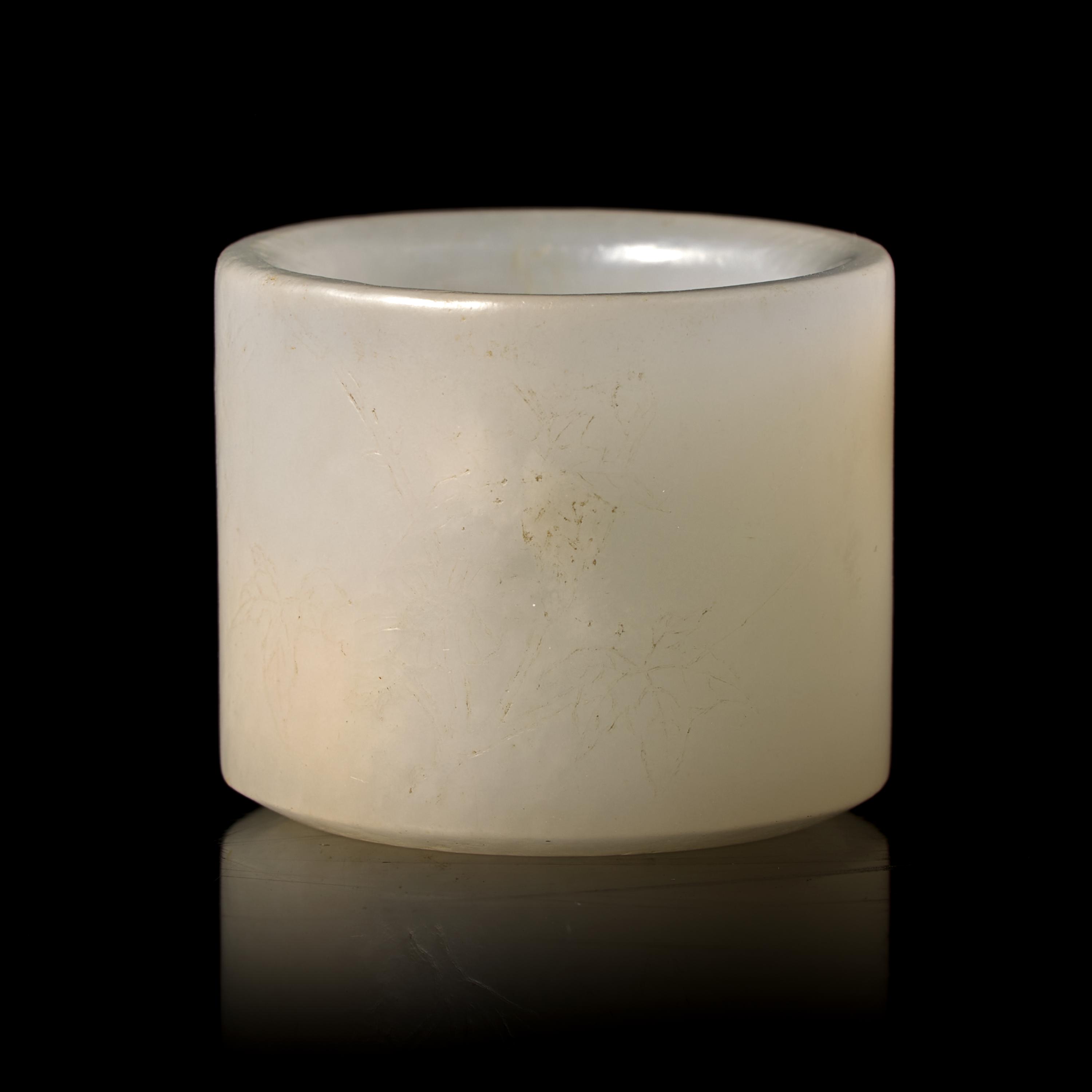 A Chinese Incised White Jade 'Poem' Archer's Ring, 18th/19th Century 清中晚期 白玉詩文扳指