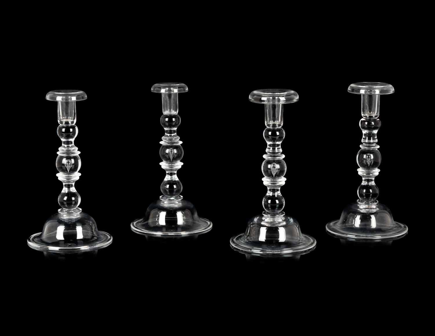 A Set of Four Steuben Glass Candlesticks