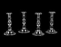 A Set of Four Steuben Glass Candlesticks
