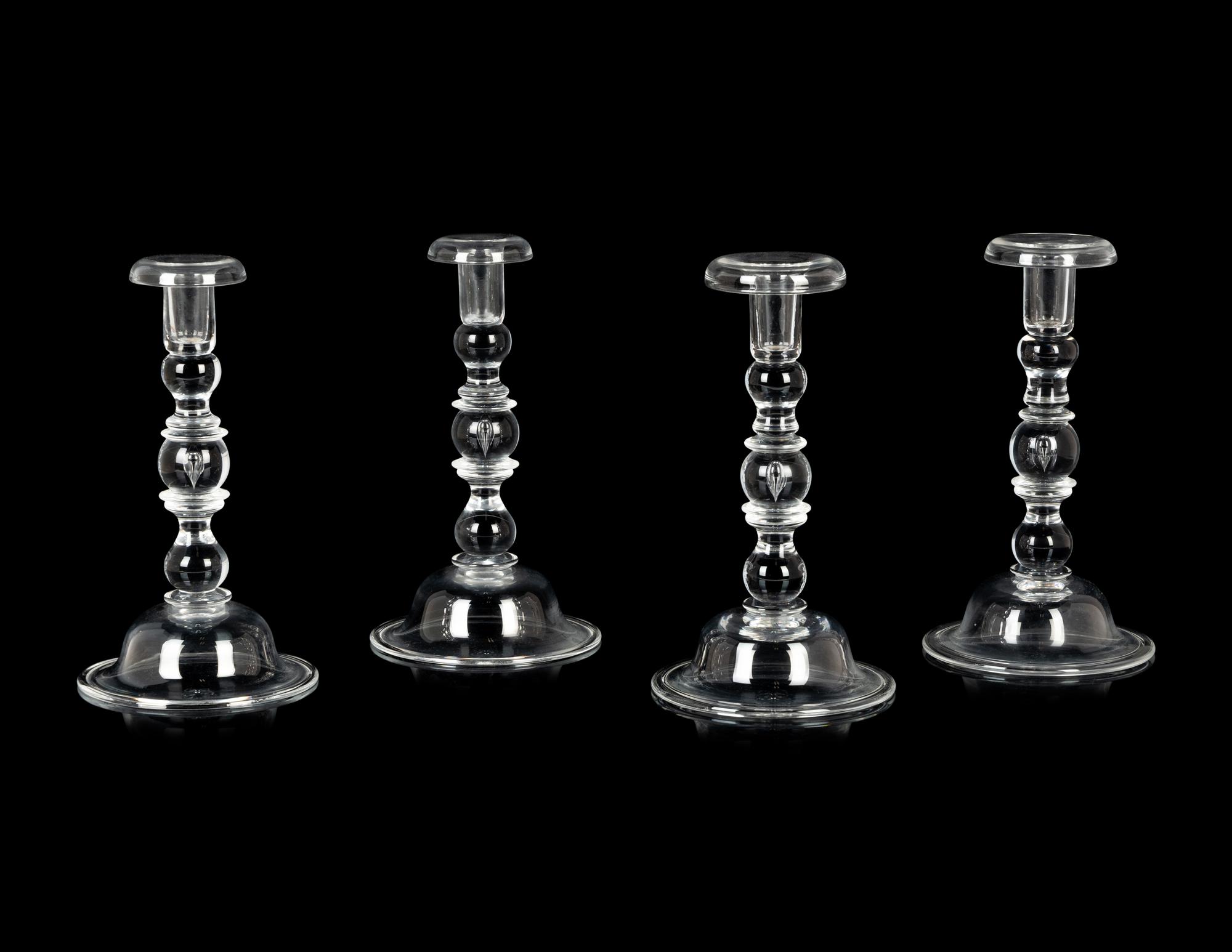 A Set of Four Steuben Glass Candlesticks