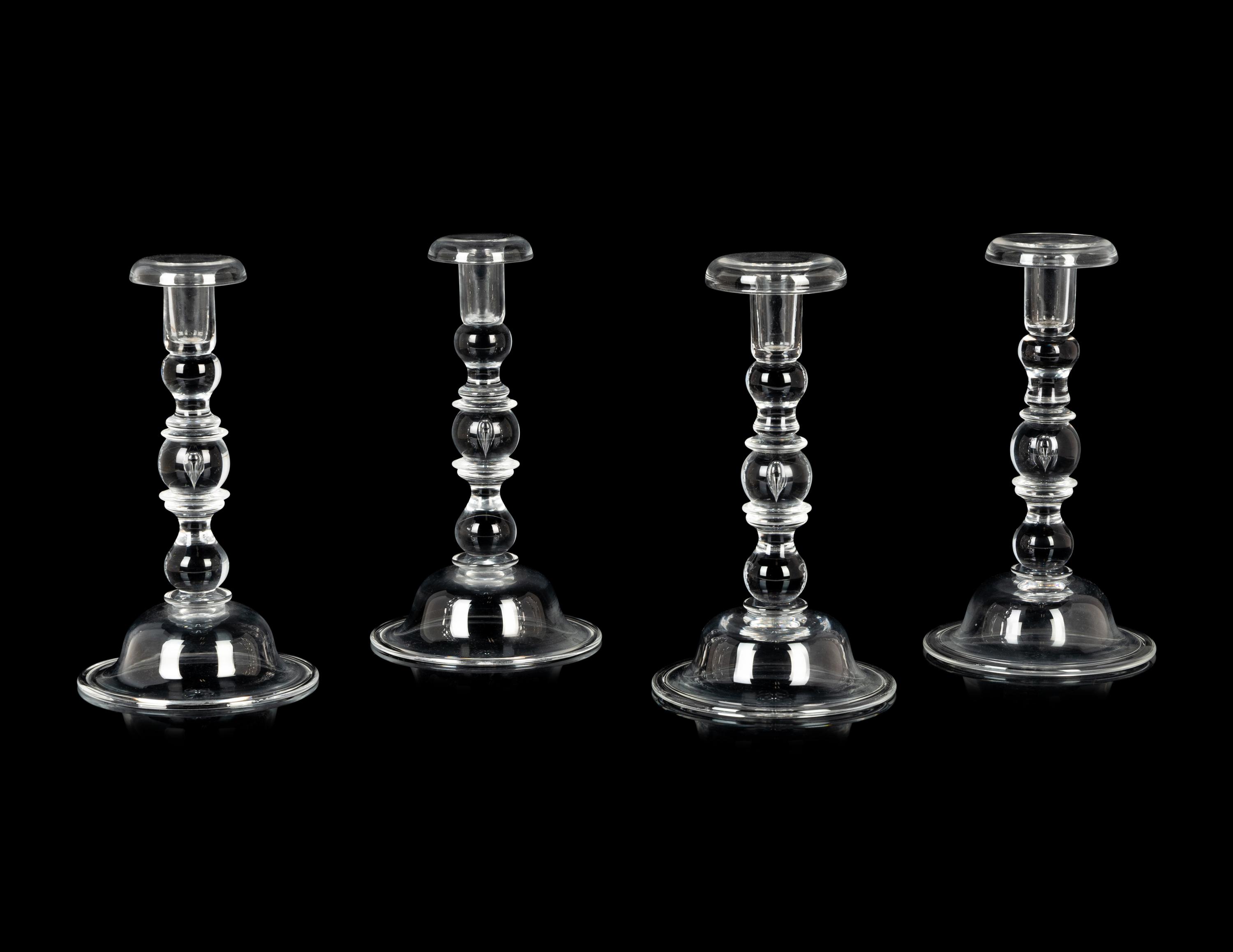 A Set of Four Steuben Glass Candlesticks