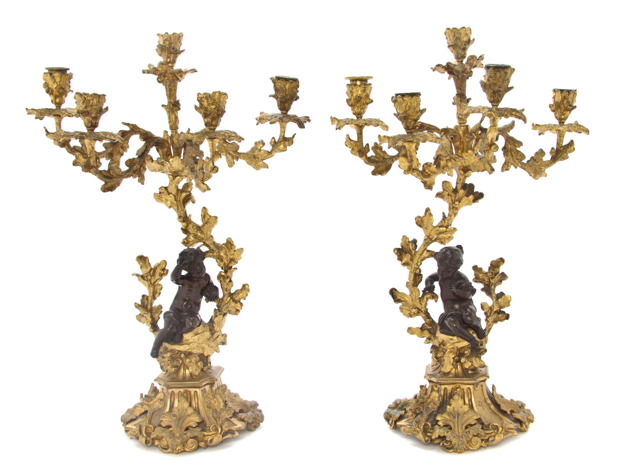 A Pair of Neoclassical Patinated Bronze Five-Light Figural Candelabra, Height 21 inches.